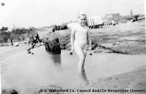 Tramore, County Waterford. Marie Stokes on the strand at Tramore with the town visible in the background
