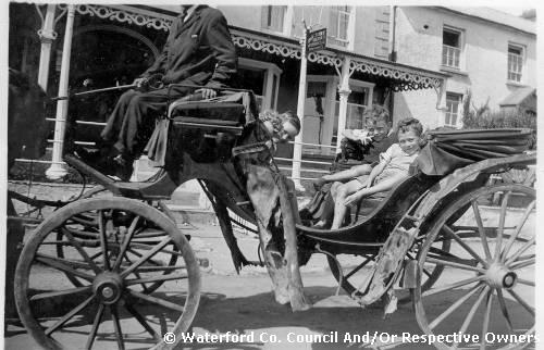 Tramore, County Waterford. Horse and carriage. Tramore hotel in the background